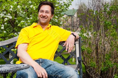 Middle Aged Man Relaxing In Garden