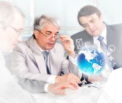 Portrait of group of businessmen at the computer. Office backgro
