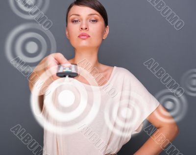 Portrait of a beautiful fashionable elegant woman with remote co