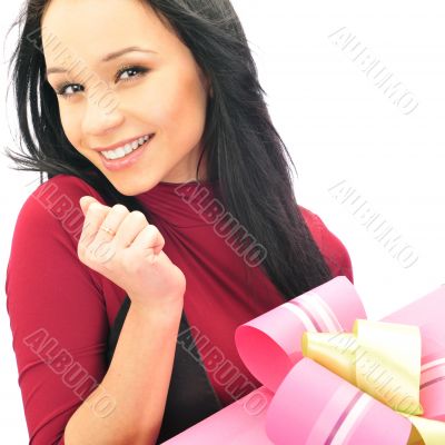 Beautiful European young woman holding her huge gift against whi