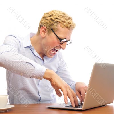 Portrait of funny man screaming during typing a document on his 