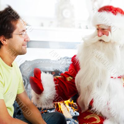 Two adult men - old father wearing Santa Claus suit and his adul