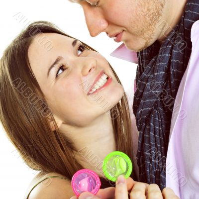 Portrait of young couple standing together and embracing and hol Portrait of young couple standing together and embracing and hol