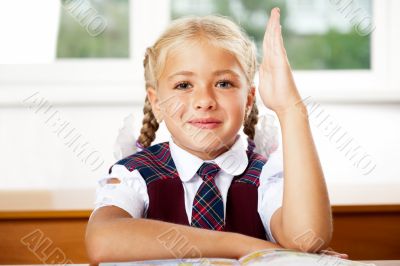 Portrait of a young girl in school at the desk.Horizontal Shot. 