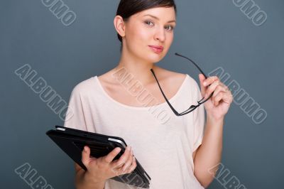 Portrait of young pretty woman holding tablet computer and glass