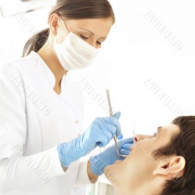 At dentist`s office - young woman dentist working