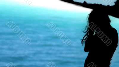 Beautiful brunette woman resting on the beach