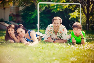 Artistic lifestyle photo of full happy family laying relaxed on 