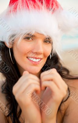 Young beautiful woman wearing christmas hat showing heart shape 