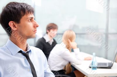 Closeup portrait of a smart young businessman smiling and his co