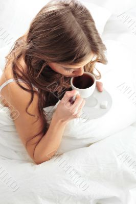 Fashion portrait of young elegant woman in bed