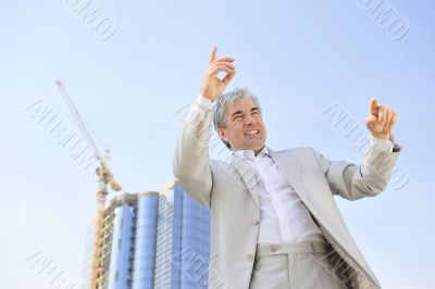 Portrait of a businessman with arms open.