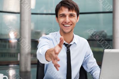 Happy mature business man offering a welcoming hand