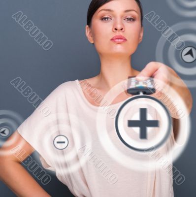 Portrait of a beautiful fashionable elegant woman with remote co