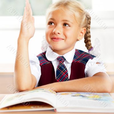 Image of smart child reading interesting book in classroom. Hori