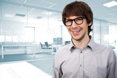 Closeup of a young smiling business man standing against big win