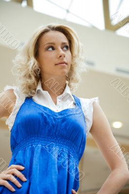 A portrait of a young business woman in a hall of an office buil