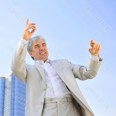 Portrait of a businessman with arms open.