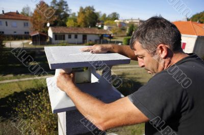 Builder finishing a gatepost