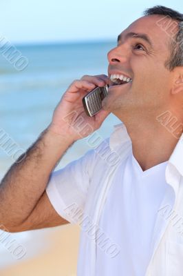 Mature man laughing into his cellphone