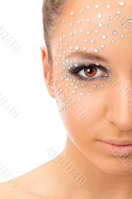 Portrait of young beautiful woman with crystals on face - isolat