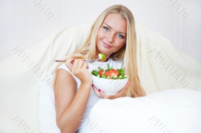 Closeup portrait of a beautiful slender girl eating healthy food