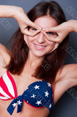 20-25 years old beautiful woman in swimsuit with american flag a