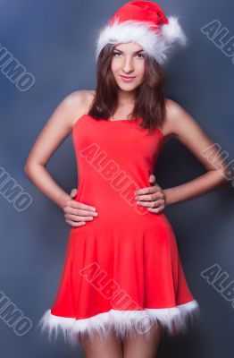 20-25 years od beautiful woman in christmas dress posing against