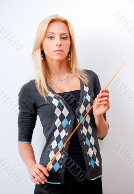 Portrait of young teacher pointing on white marker board in mode