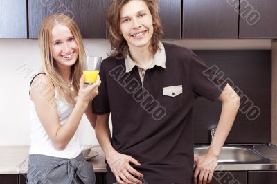 Playful young couple in their kitchen.