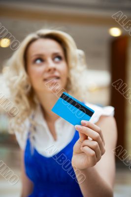 Photo of young joyful woman with shopping bags inside mall 