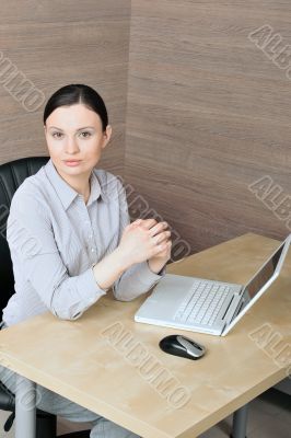 Portrait of a beautiful young businesswoman with hands clasped.