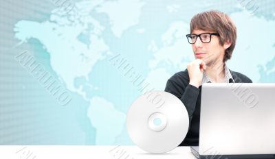 Portrait of happy young business man working using laptop agains Portrait of happy young business man working using laptop agains