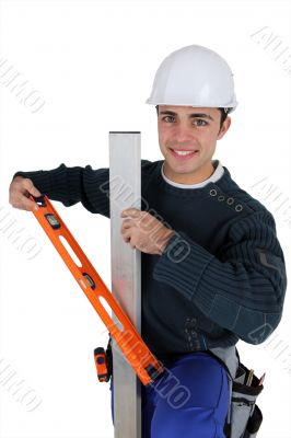 Worker with level spirit on white background