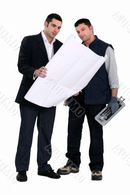 Architect stood with male labourer Architect stood with male labourer