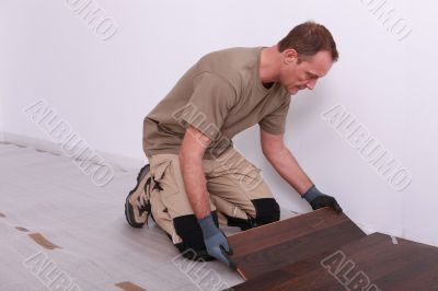 Man laying laminate flooring Man laying laminate flooring
