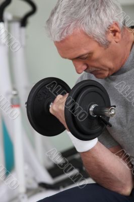 man lifting weight in sports room