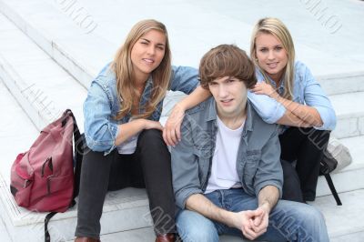Three teenage friends sat on steps Three teenage friends sat on steps