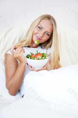 Closeup portrait of a beautiful slender girl eating healthy food