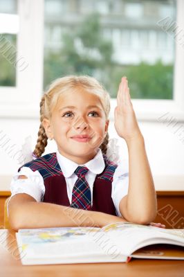 Image of smart child reading interesting book in classroom. Vert