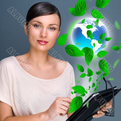 Portrait of young woman standing indoors at her office and worki