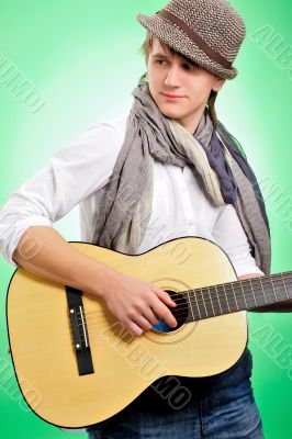 Closeup portrait of cute caucasian man playing the guitar over g