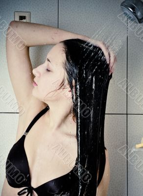 Beautiful young woman take shower