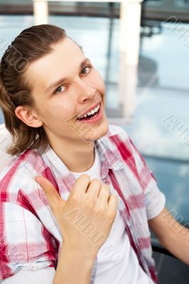 Happy satisfied young man sitting relaxed on 