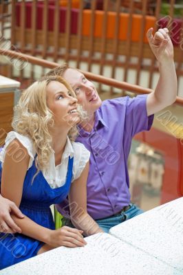 Happy couple at a shopping center smiling and looking&quot;magen