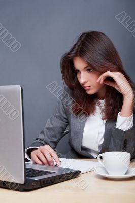 Portrait of an adorable business woman working at her desk with 