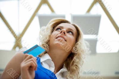 Beautiful shopping woman holding a credit card