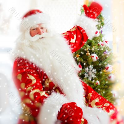 Santa sitting at the Christmas tr