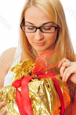 Beautiful student woman holding a gift isolated on white
