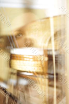 Young woman standing at the window having tea, day dreaming